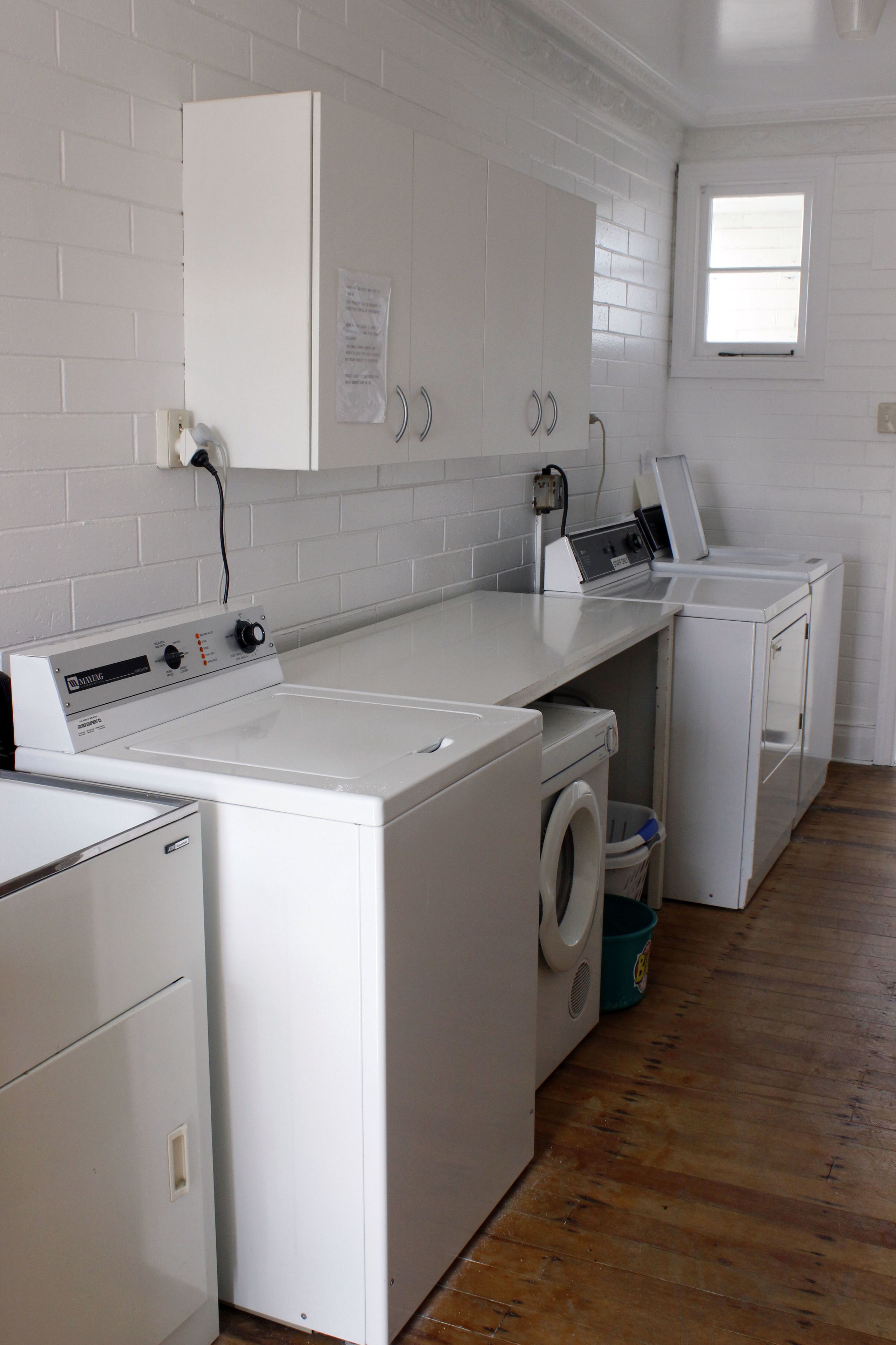 A laundry room with a washing machine, dryer, and stacked washer-dryer unit.