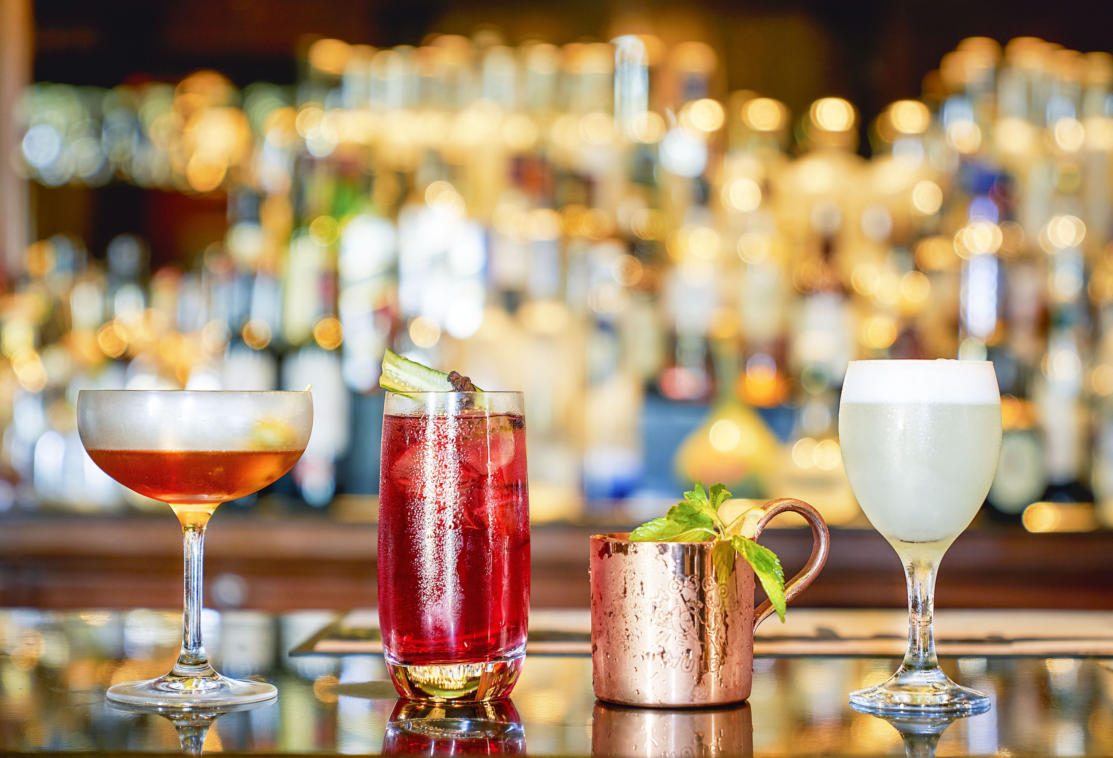 A bar with various drinks in different types of glasses.