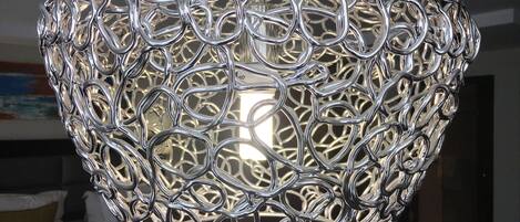 A metallic, intricately designed pendant light fixture.