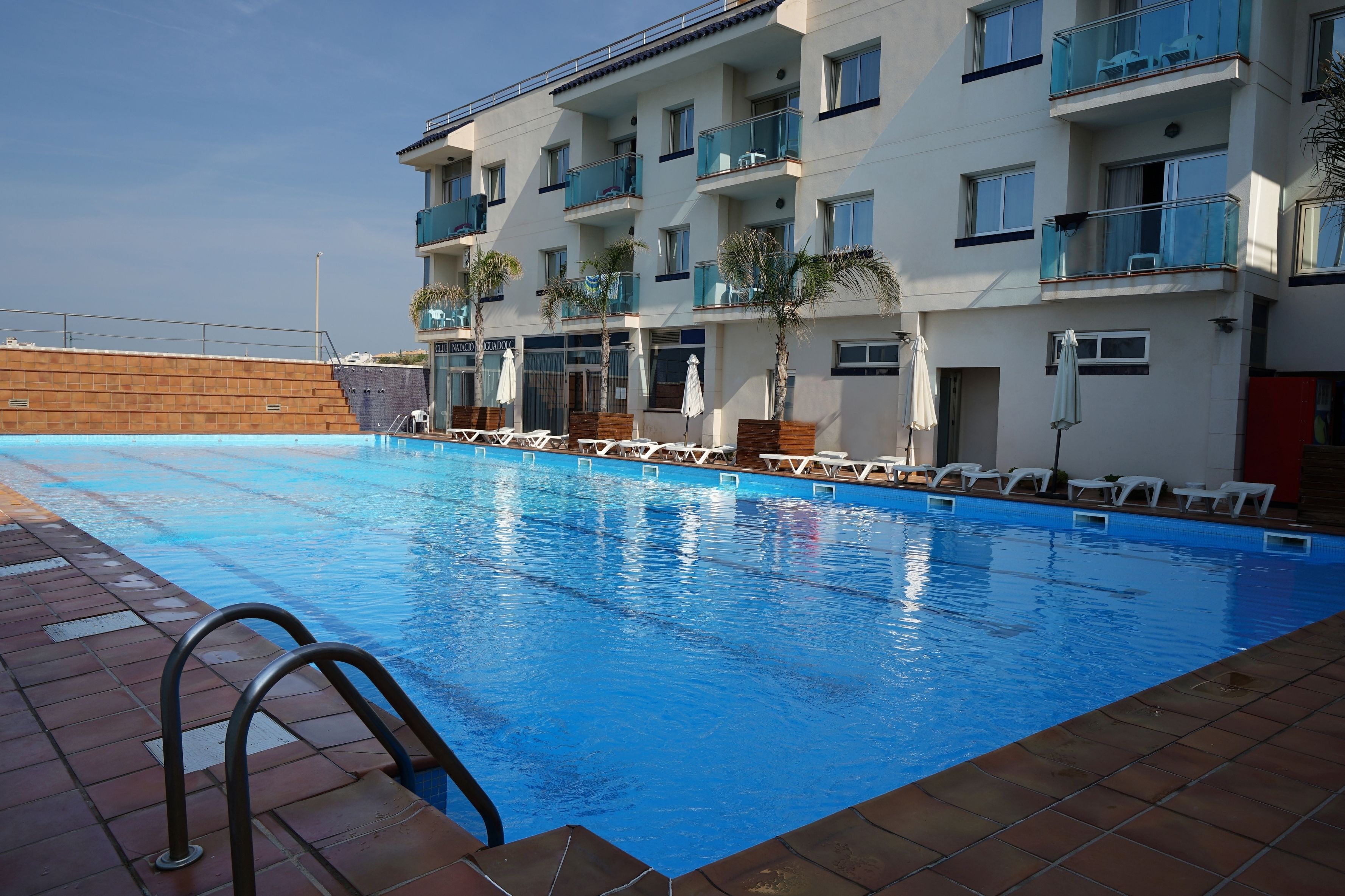 Seasonal outdoor pool, open 10:00 AM to 6:00 PM, pool umbrellas