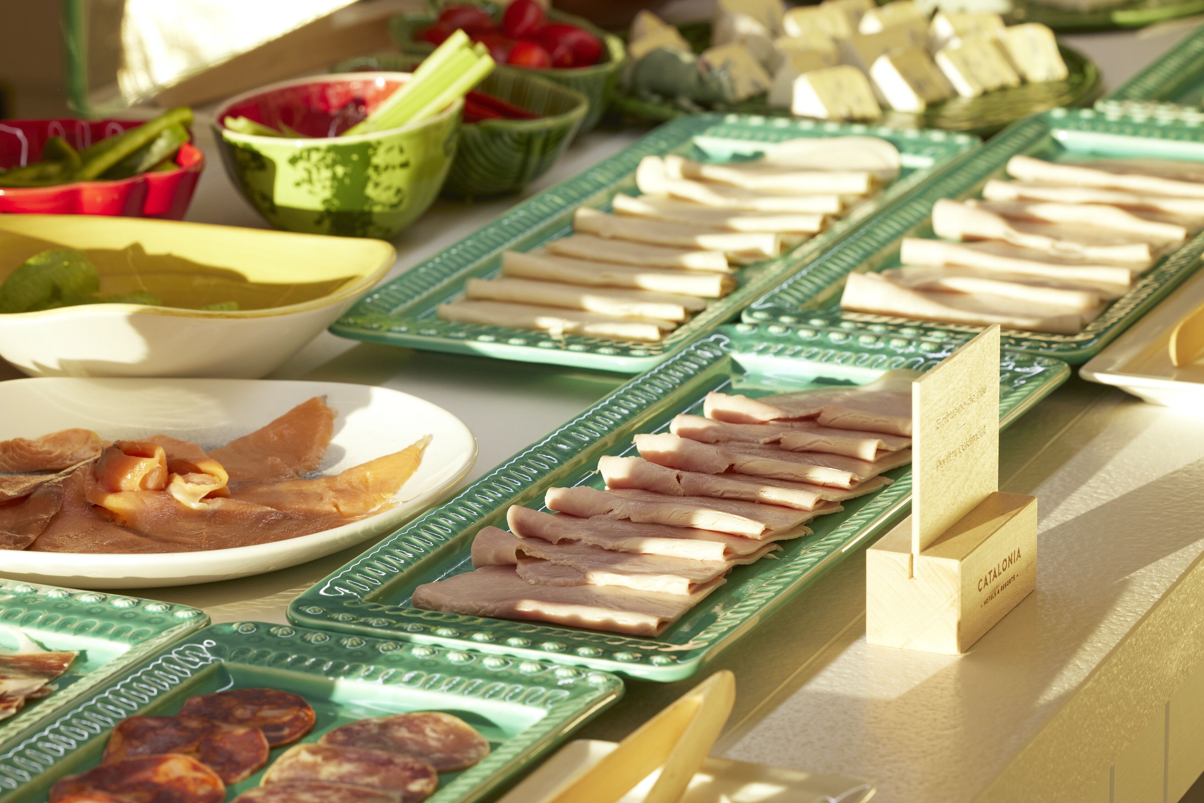 A buffet with various food items including meats and vegetables.