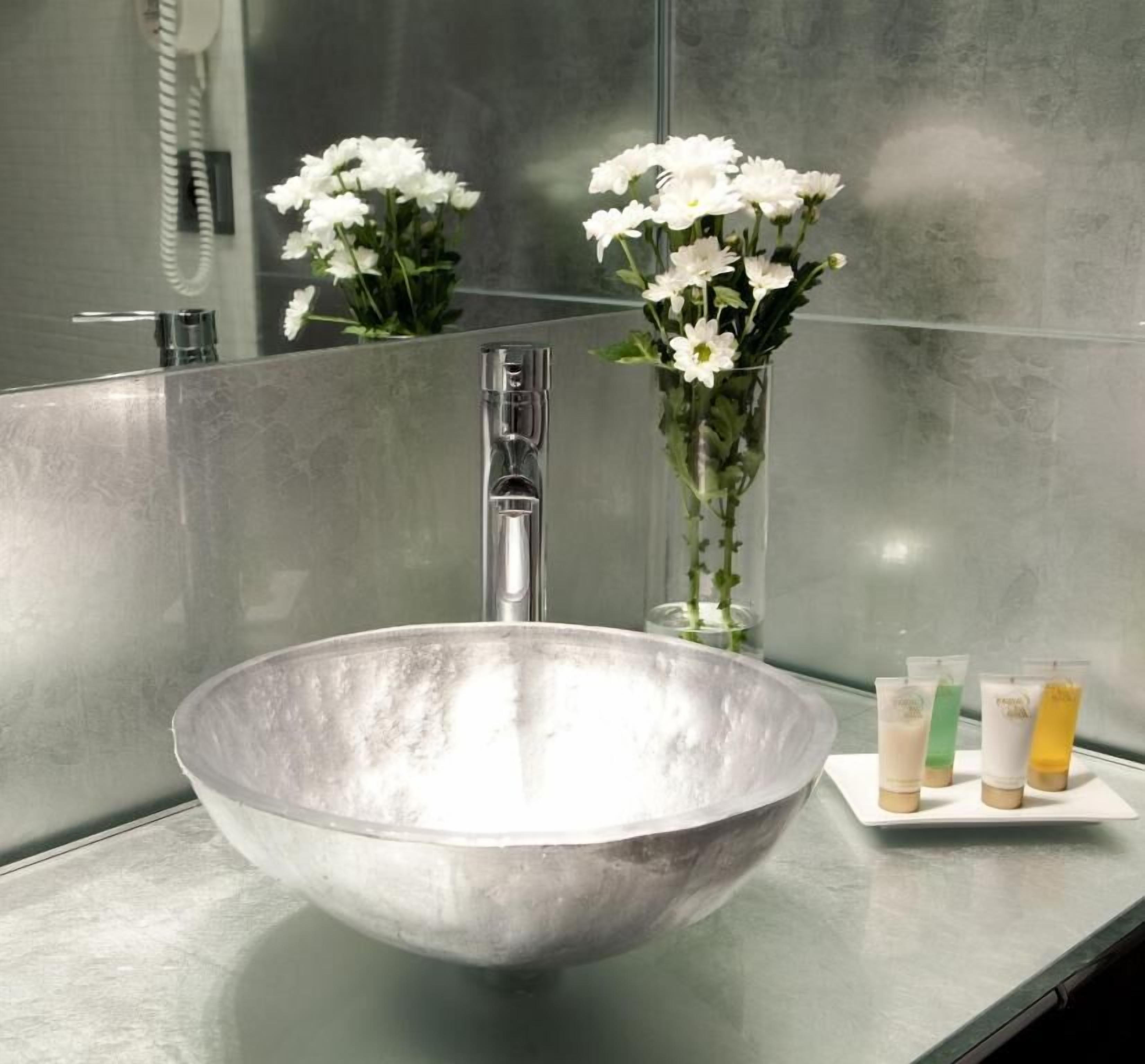 designer toiletries, hair dryer, slippers, towels