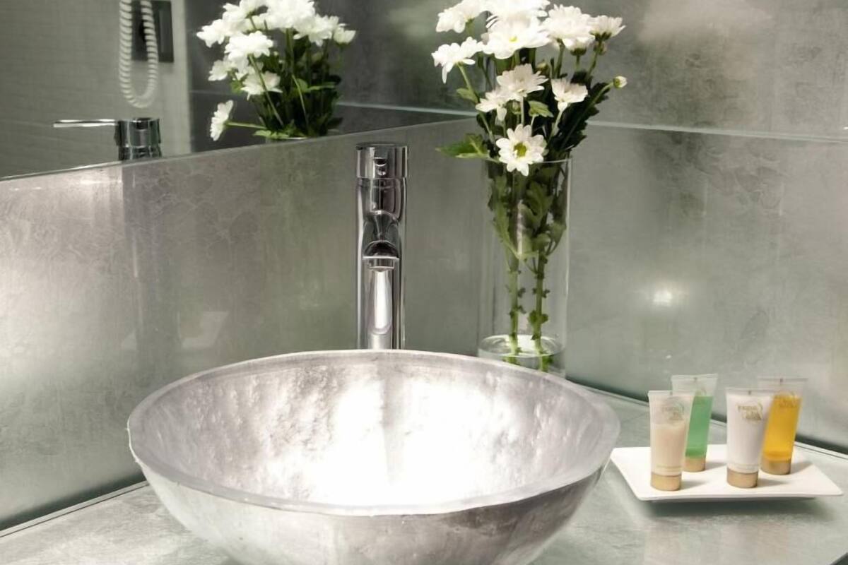 designer toiletries, hair dryer, slippers, towels