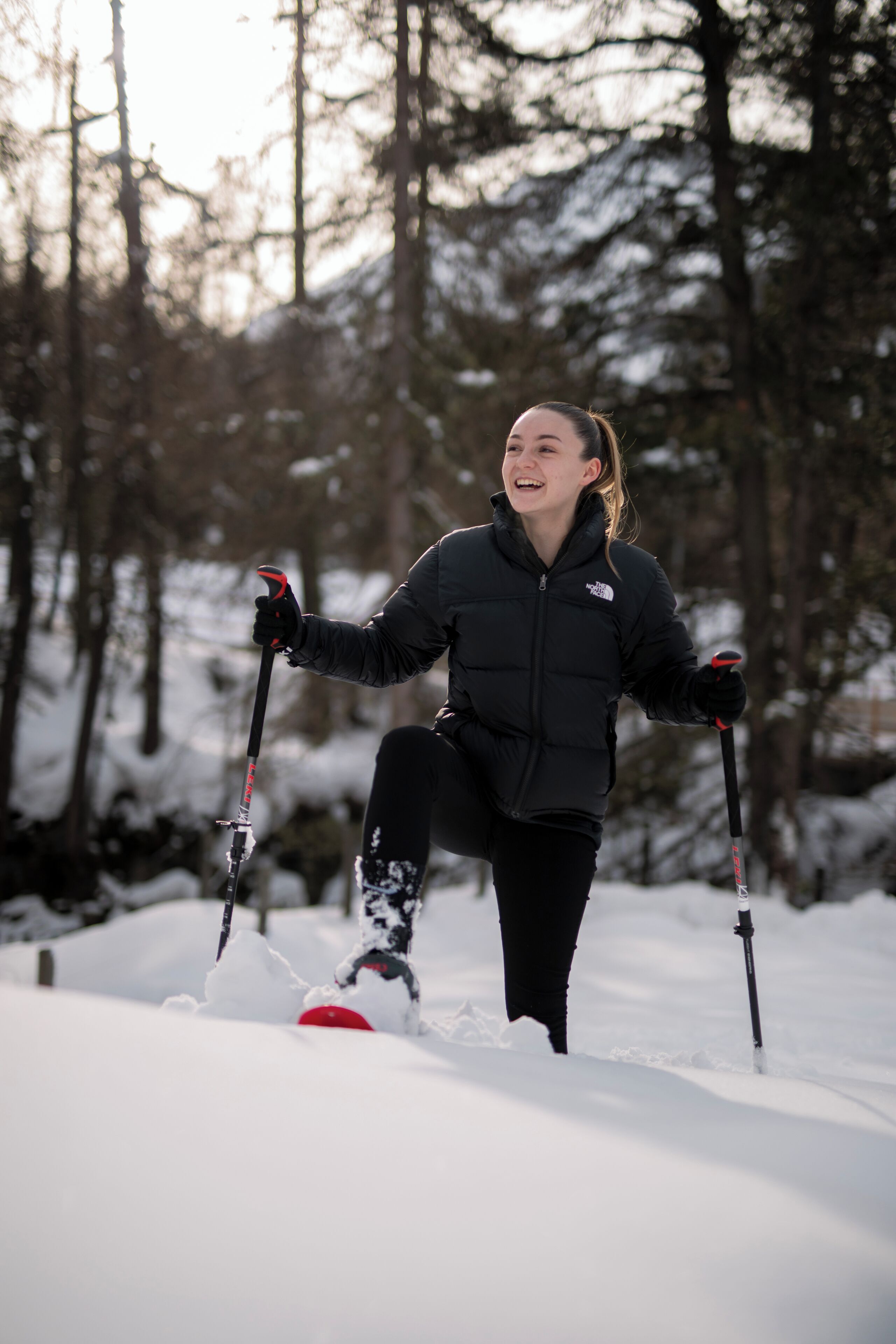 A person skiing in a snowy forest.