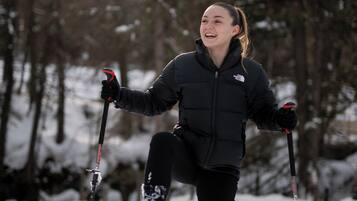 A person skiing in a snowy forest.