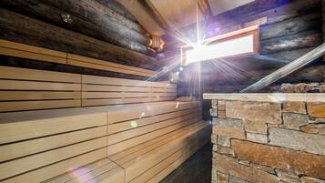 A wooden bench area with a stone wall and a window.