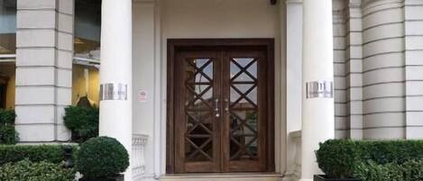 The Ashburn Hotel entrance with a double door, steps, and a lamp.