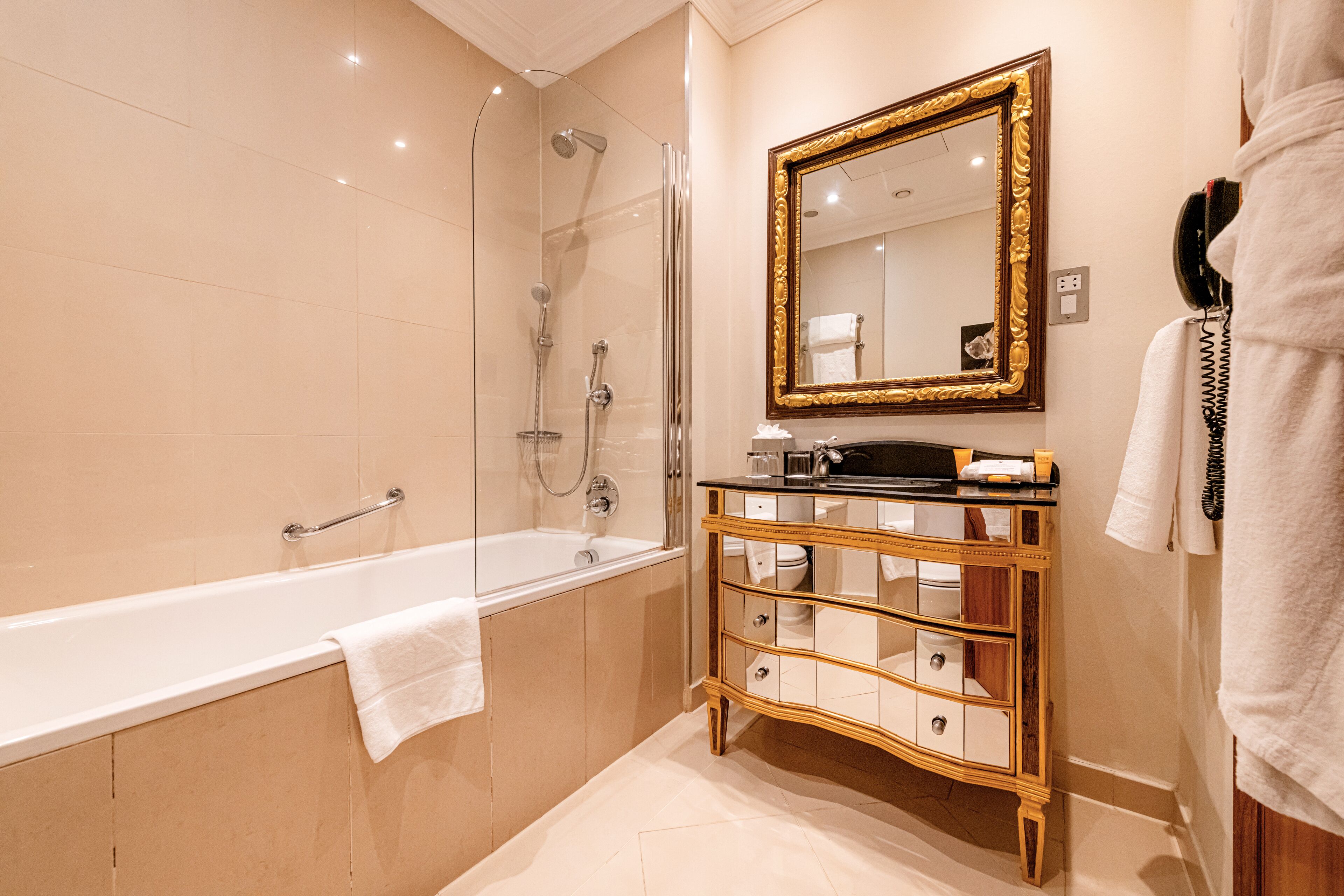 combined shower/bathtub, designer toiletries, hair dryer, bathrobes