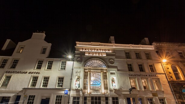 The exterior of the Salutation Hotel with its classic architecture, large arched entrance, and illuminated signage. - Salutation Hotel (Perth)