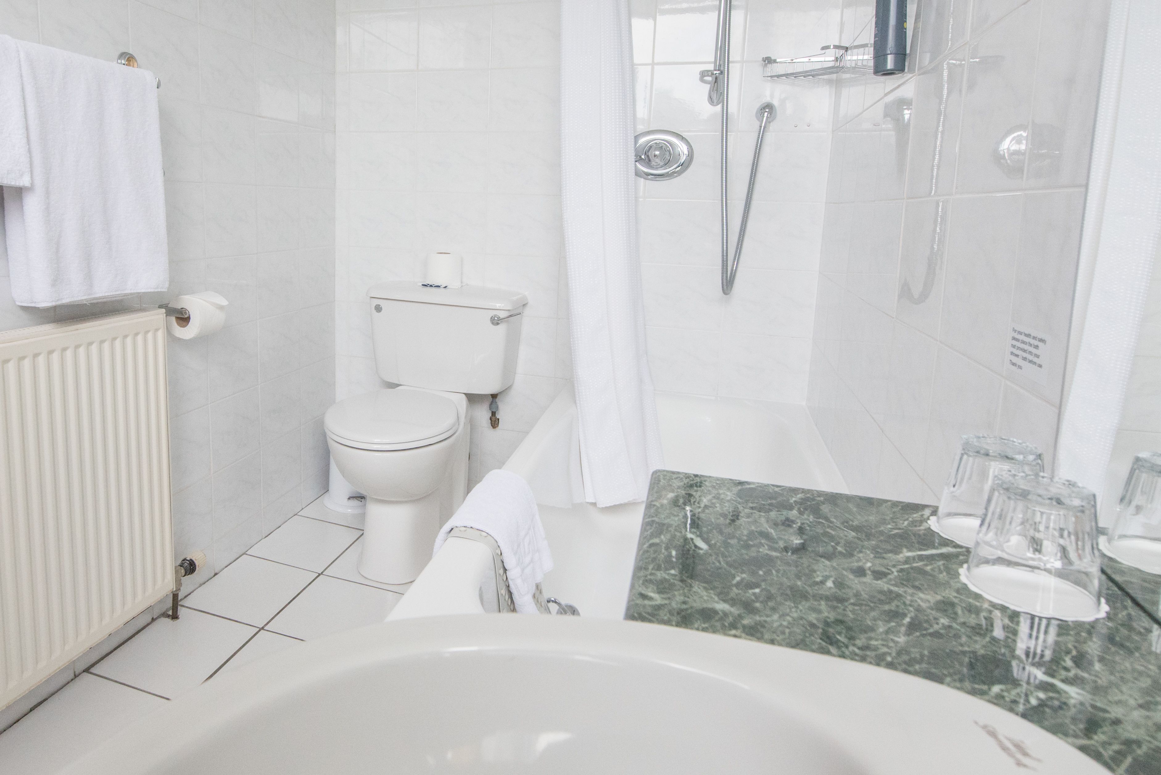 A modern bathroom with a toilet, bidet, and bathtub.