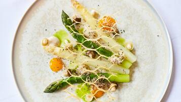 A plate of food with various vegetables and garnishes.