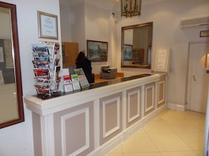 Welcome to the hotel reception area, where guests can check in and access a range of information and services.