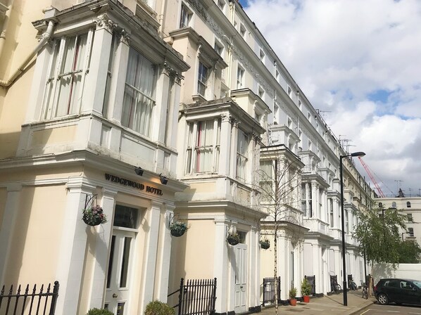 Classic hotel with a symmetrical facade, ornate detailing, and a charming entrance.