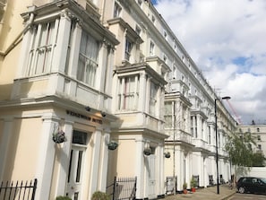 Classic hotel with a symmetrical facade, ornate detailing, and a charming entrance.