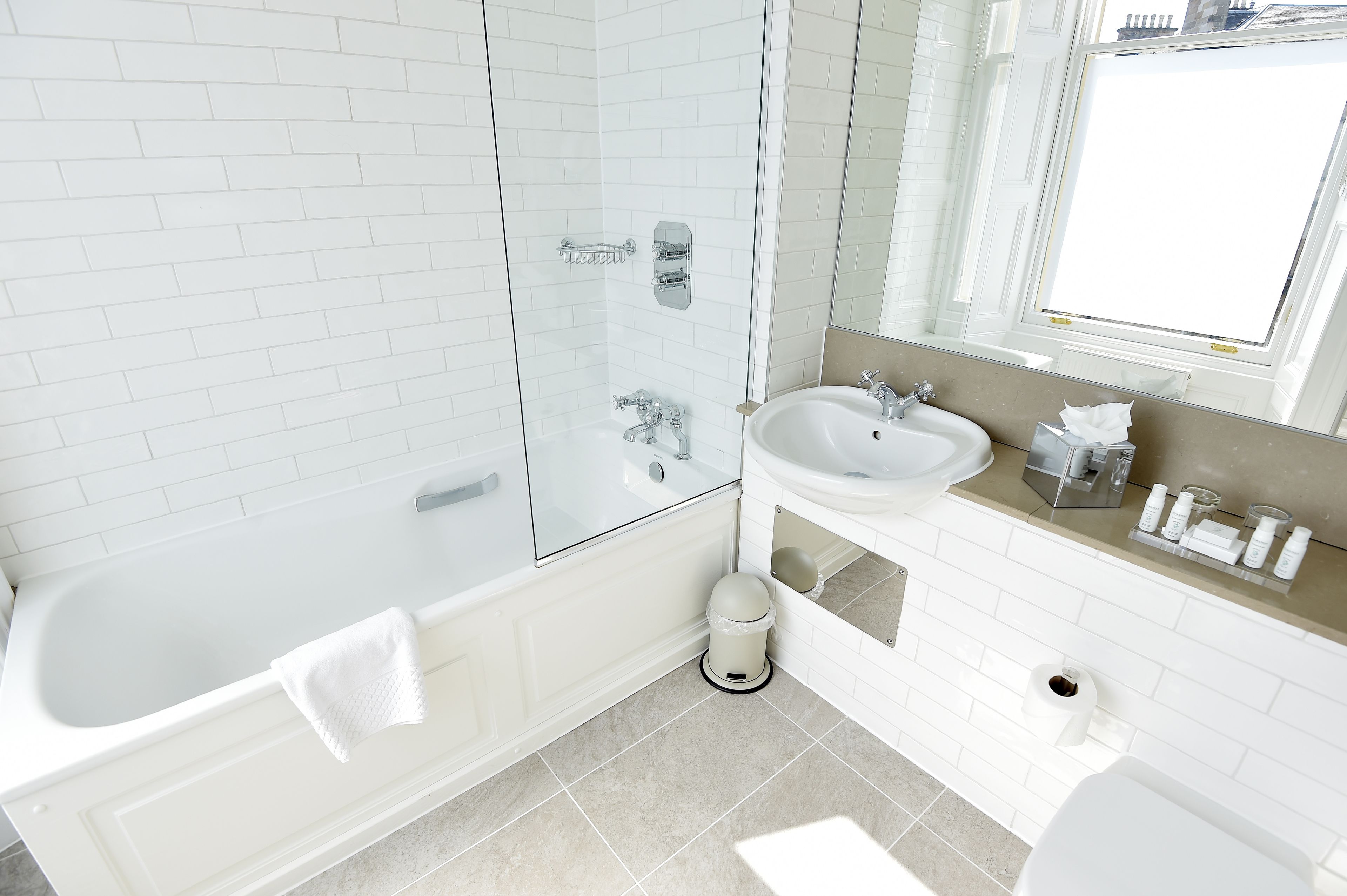 designer toiletries, hair dryer, slippers, towels