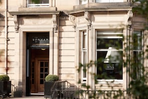 A building with a classic architectural style, featuring a prominent entrance with a sign that reads "The Bonham."