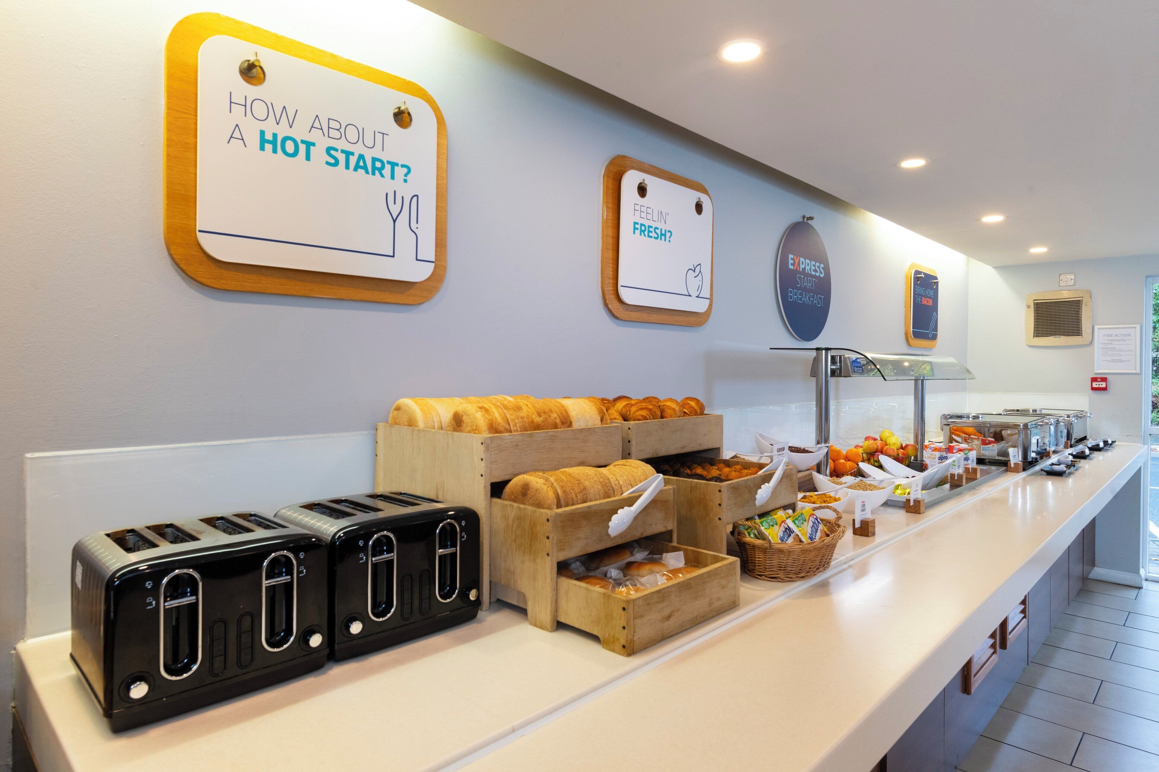 A breakfast buffet with various food items and a toaster station.