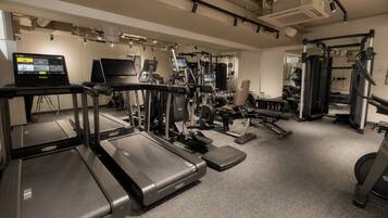 A gym with treadmills, weight machines, and exercise equipment.