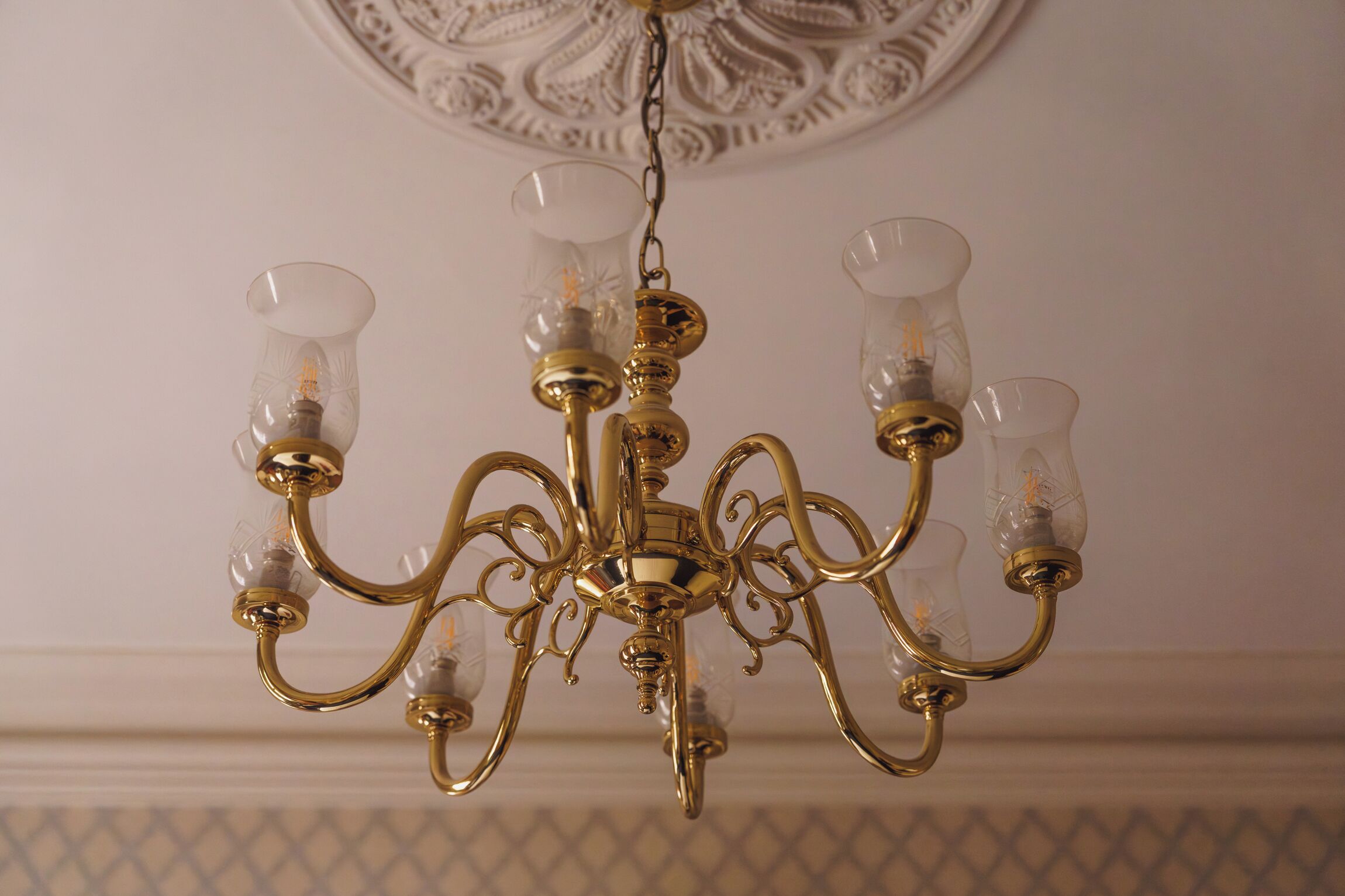 A chandelier with multiple arms and clear glass shades.