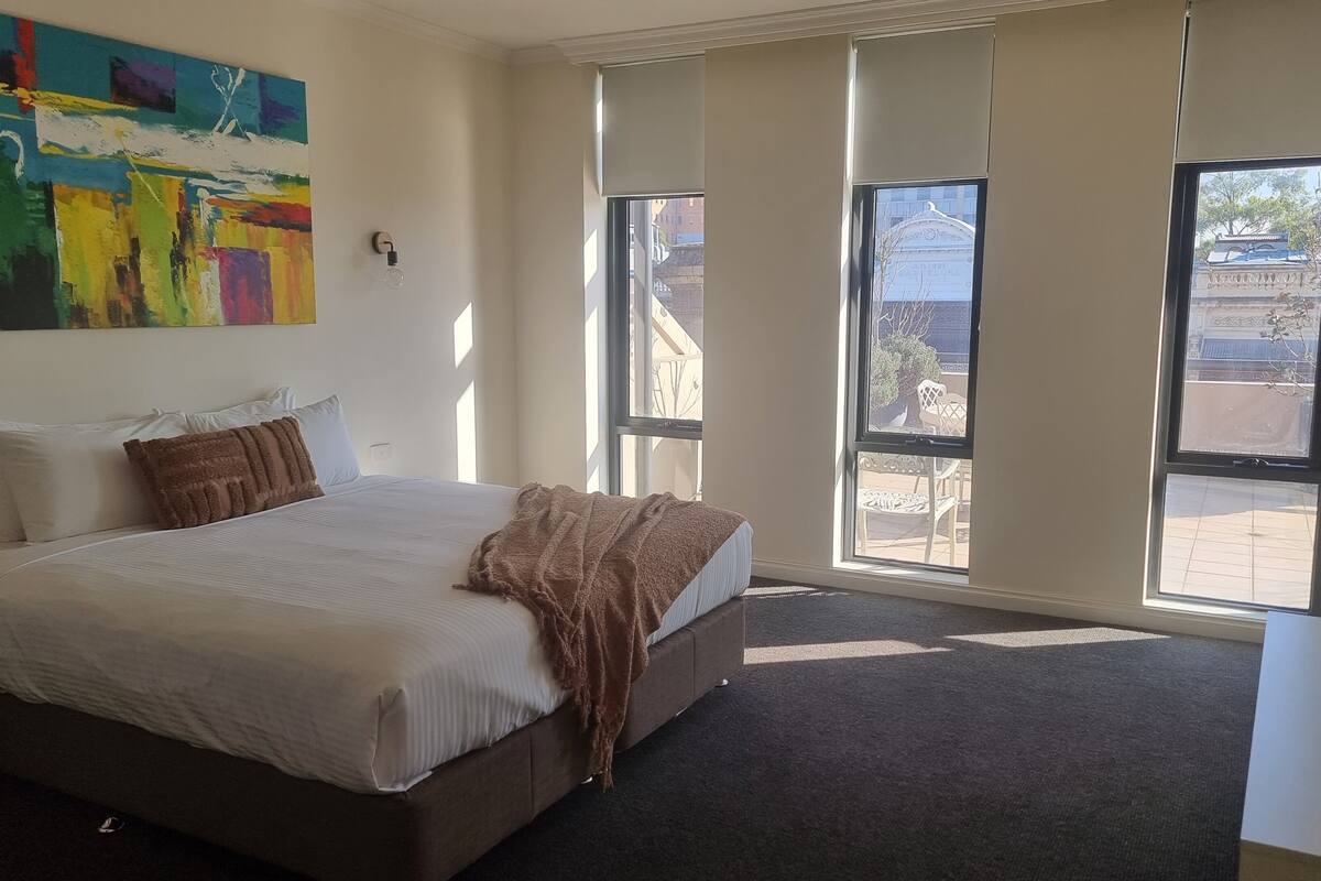 executive penthouse | hypo-allergenic bedding, desk, blackout curtains, soundproofing