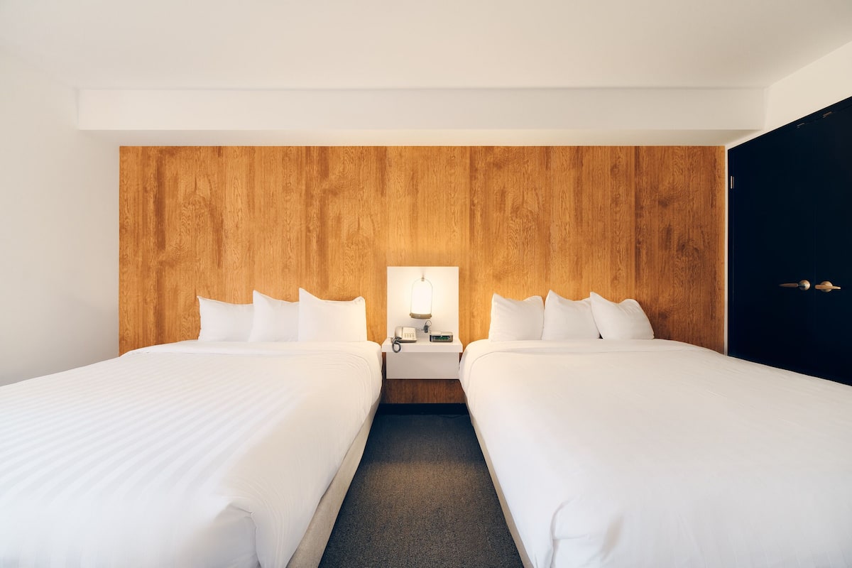 deluxe room, 2 queen beds | 2 bedrooms, hypo-allergenic bedding, pillow-top beds, in-room safe