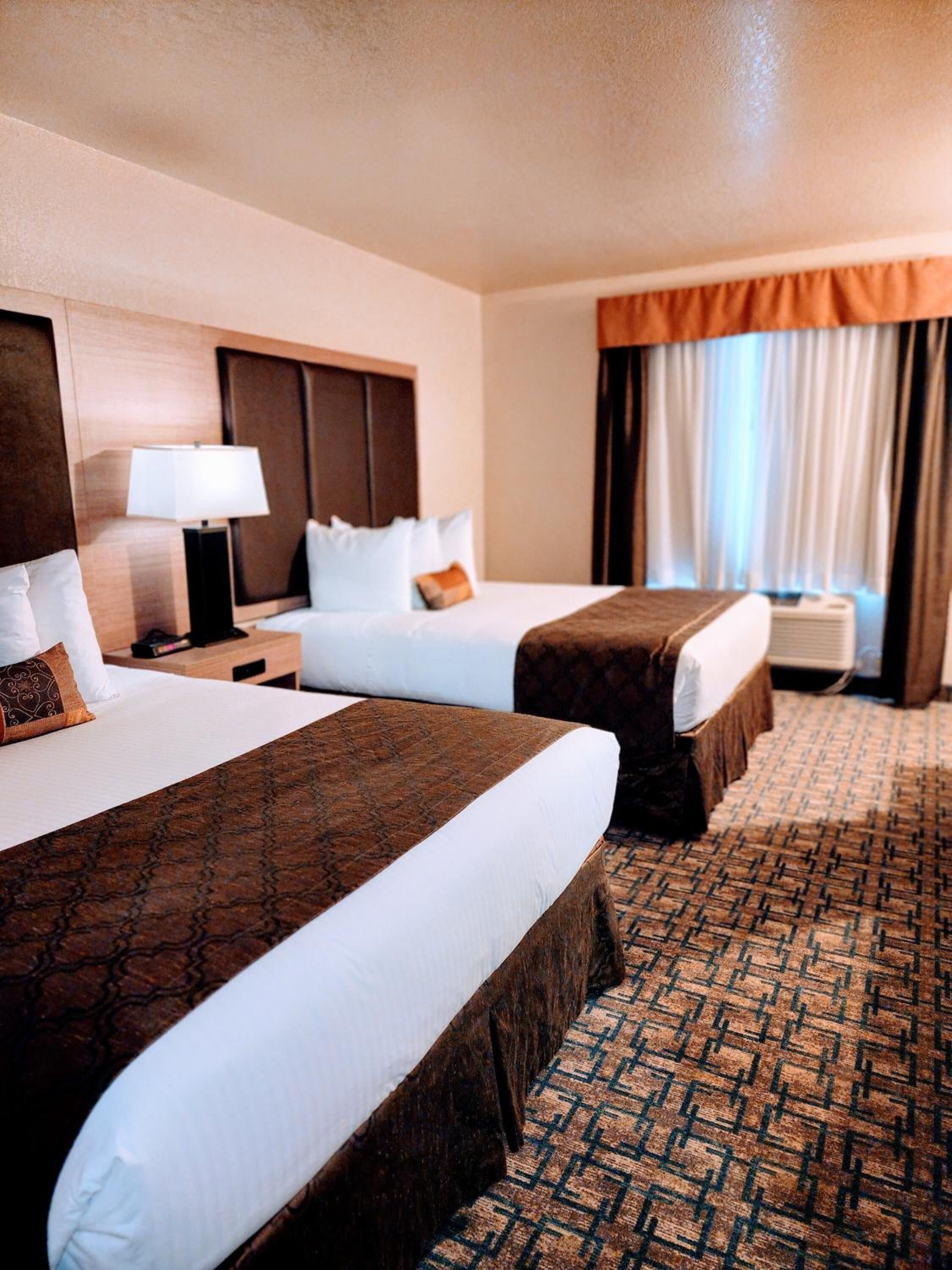 Premium bedding, desk, laptop workspace, blackout drapes