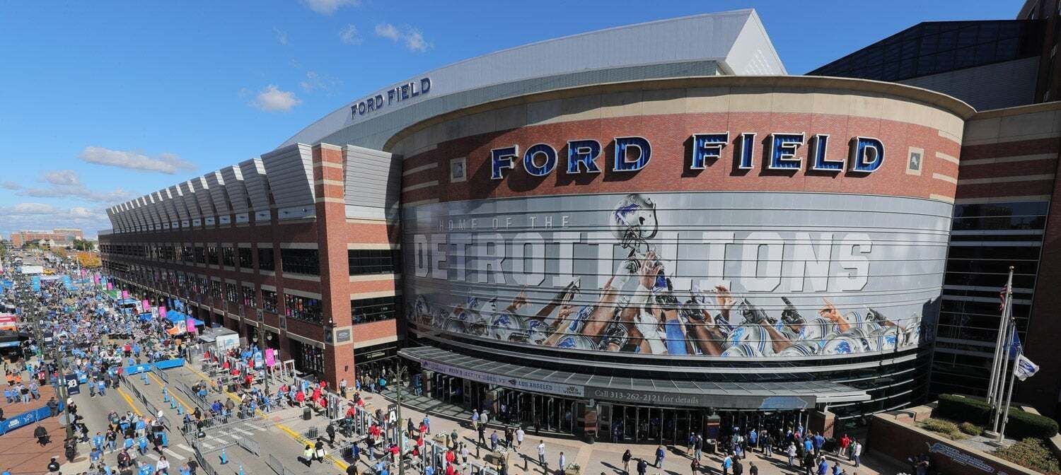 A stadium with the name 'Ford Field' and a large mural depicting football players.