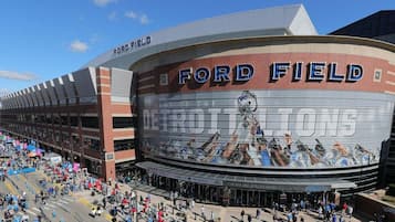 A stadium with the name 'Ford Field' and a large mural depicting football players.
