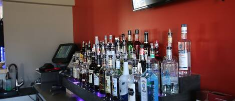 A bar area with a variety of liquor bottles and a Jackson-Triggs wine box.