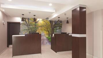 A reception area with a modern design, featuring two wooden reception desks, a large wall mural of a forest scene, and recessed ceiling lighting.