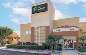 A Stay America hotel with a modern facade, a large glass window section, and a visible lobby area. - Extended Stay America Suites San Diego Fashion Valley (San Diego)