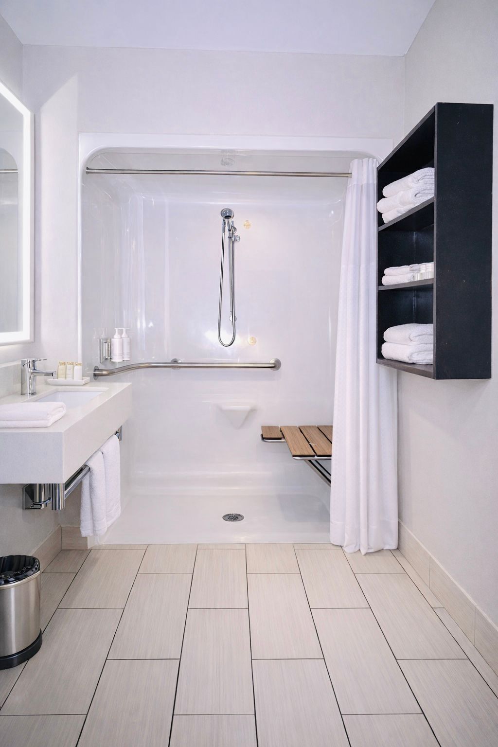 A modern bathroom with a bathtub, a shower, a sink, and a shelf with towels.