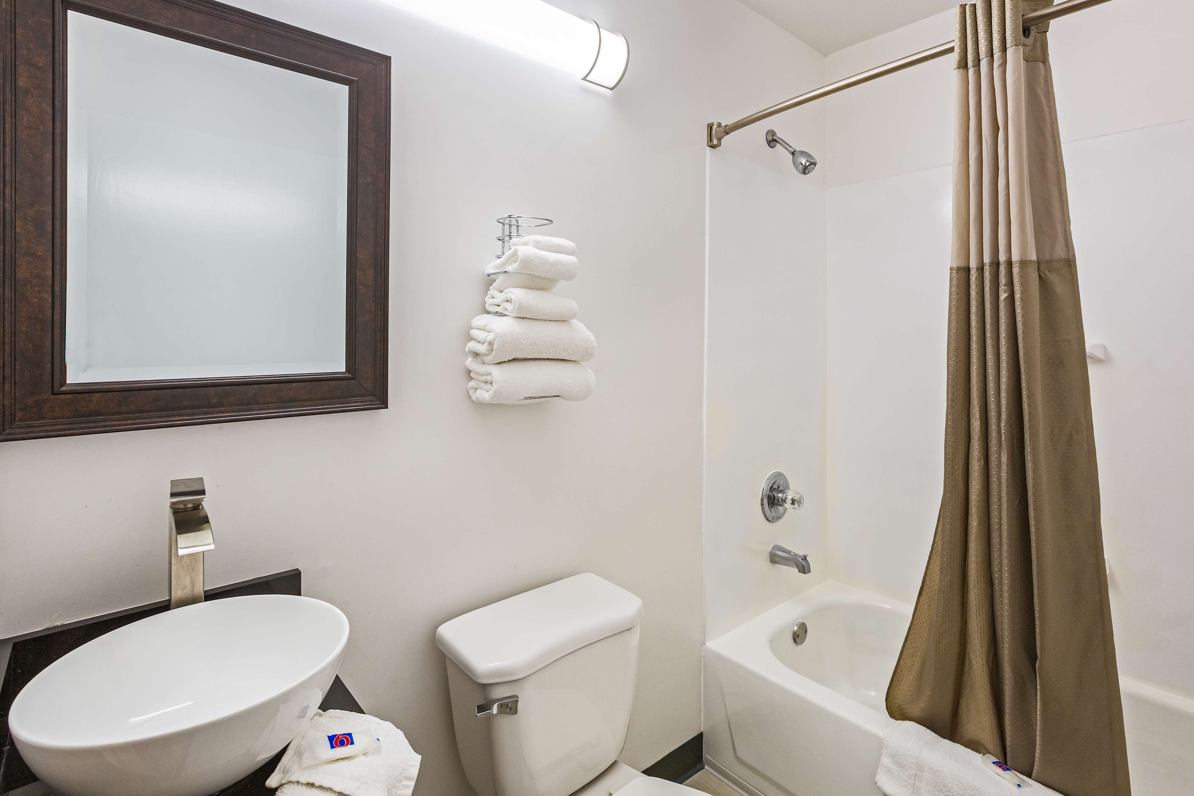 A bathroom with a sink, toilet, and bathtub.