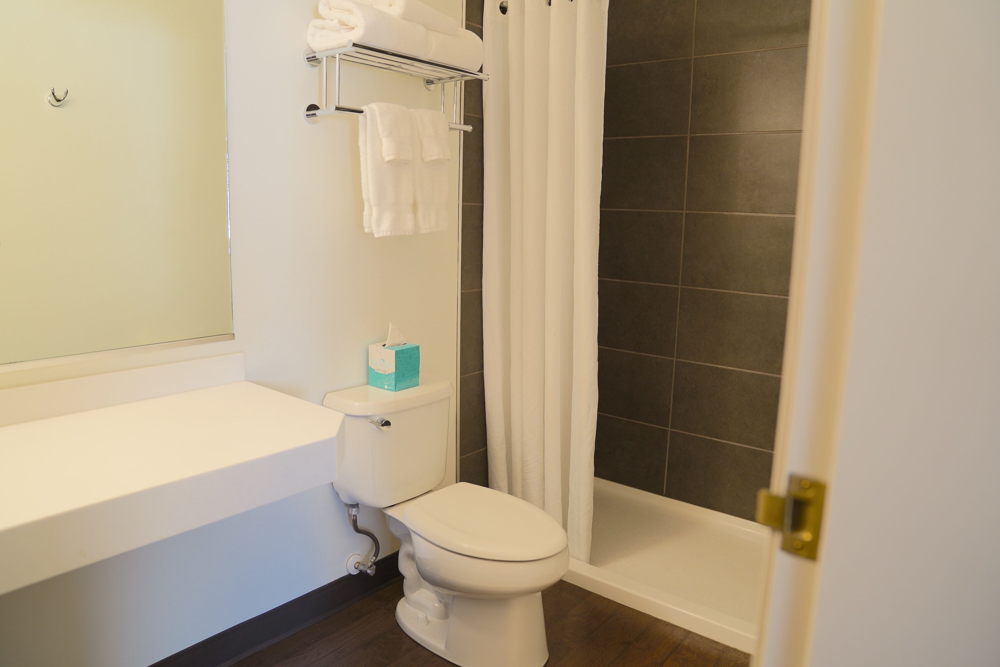 A bathroom with a white toilet, a white sink, and a bathtub.