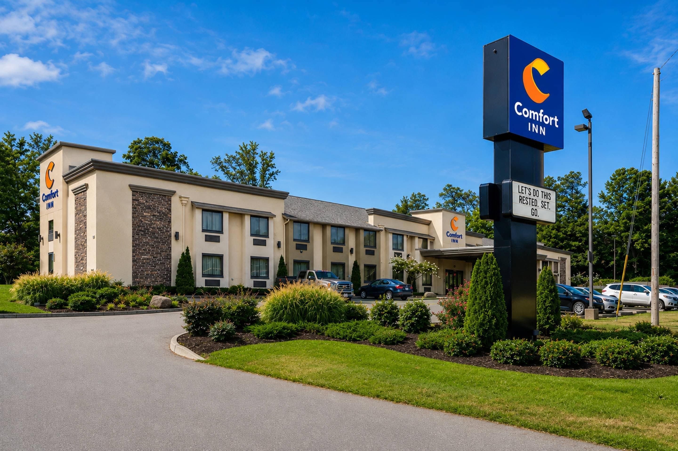A Comfort Inn hotel with a modern design, featuring a prominent blue sign with the brand logo.