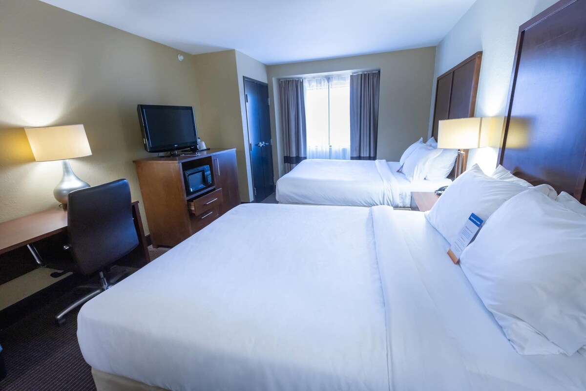 Premium bedding, desk, laptop workspace, blackout drapes