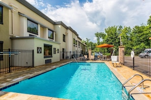 A swimming pool with a no diving sign, outdoor seating, and a brick wall. - Comfort Inn Tupelo Central (Tupelo)