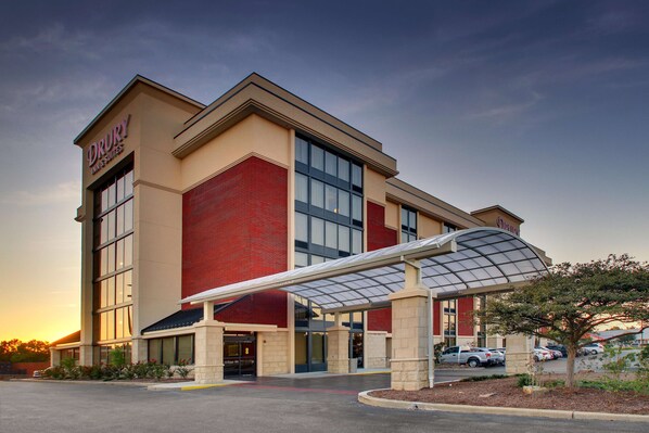 A Drury Inn & Suites building with a covered entrance, brick facade, and large windows. - Drury Inn & Suites Evansville East (Evansville)
