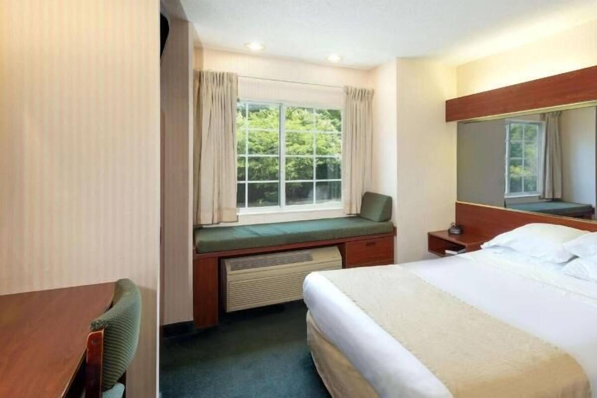 Desk, laptop workspace, blackout curtains, iron/ironing board