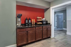 Enjoy a convenient kitchenette with a coffee station, microwave, and ample storage.