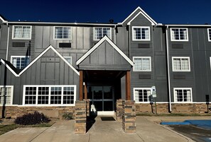 Stylish residential building with a central entrance and uniform windows.