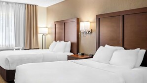 A hotel room with two beds, a bedside table with a lamp, and a large window with curtains. - Comfort Inn Worland Hwy 16 to Yellowstone (Worland)