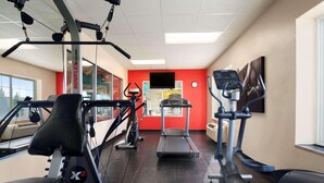 A gym with treadmills, elliptical machines, and weightlifting equipment. - Country Inn & Suites by Radisson Bismarck Waterpark (Bismarck)
