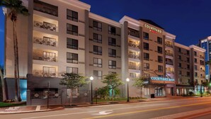 A multi-story hotel with balconies, a courtyard, and a Marriott logo.