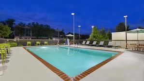 An outdoor swimming pool with a tiled deck, surrounded by lounge chairs and umbrellas. - Hampton Inn Huntsville-Arsenal/South Pkway (Huntsville)