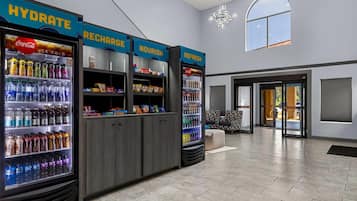 A modern lobby with hydration stations, seating, and a chandelier.