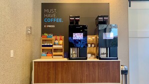 A coffee station with two espresso machines and a coffee dispenser, labeled 'Costa Coffee'. - Holiday Inn Express Hotel & Suites Downtown Minneapolis by IHG (Minneapolis)