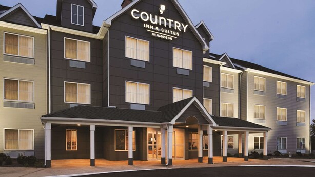 A multi-story building with a sign reading "Country Inn & Suites by Radisson." - Country Inn & Suites by Radisson, Indianapolis South, IN (Indianapolis)