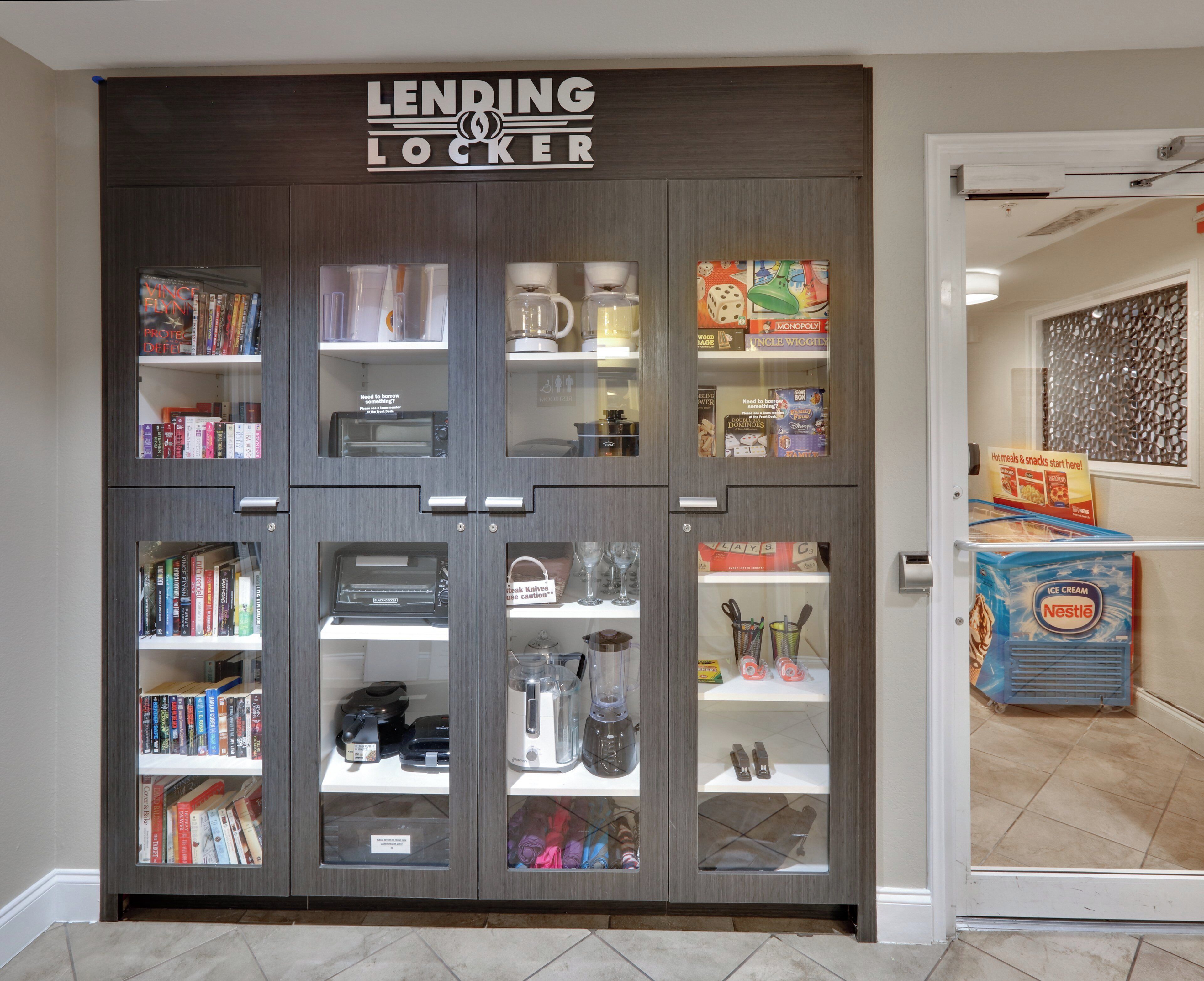 A lending locker with various items including books, kitchen appliances, and board games.