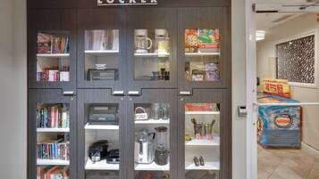 A lending locker with various items including books, kitchen appliances, and board games.